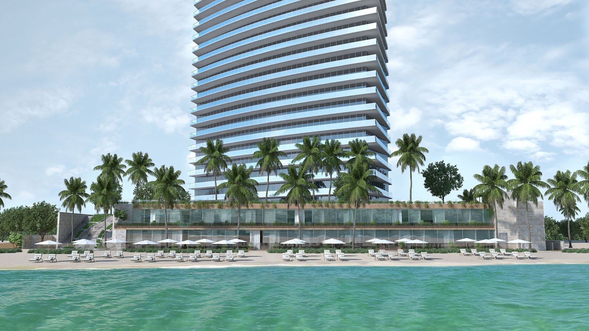 Residences by Armani Casa, Sunny Isles Beach luxury and ultra luxury preconstruction condos, beachfront tower exterior with a pool deck, palm landscaping, and lounge seating along the water.