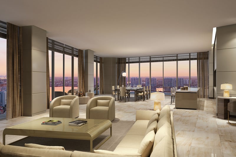 Residences by Armani Casa, Sunny Isles Beach luxury and ultra luxury preconstruction condos, corner living room with sectional seating, dining area, and sunset skyline views through wraparound glass.
