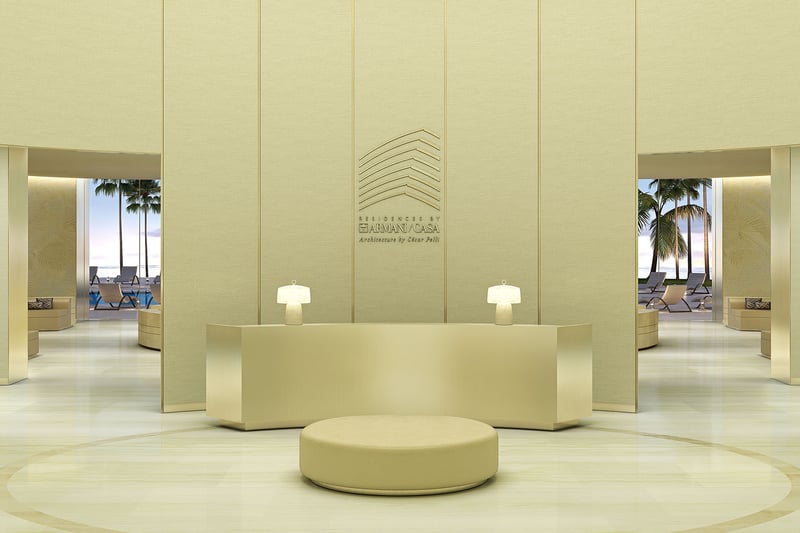 Residences by Armani Casa, Sunny Isles Beach luxury and ultra luxury preconstruction condos, double-height lobby reception with minimalist seating, pale stone finishes, and a refined concierge desk.
