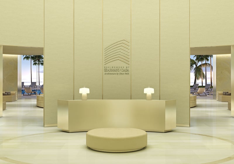Residences by Armani Casa, Sunny Isles Beach luxury and ultra luxury preconstruction condos, double-height lobby reception with minimalist seating, pale stone finishes, and a refined concierge desk.