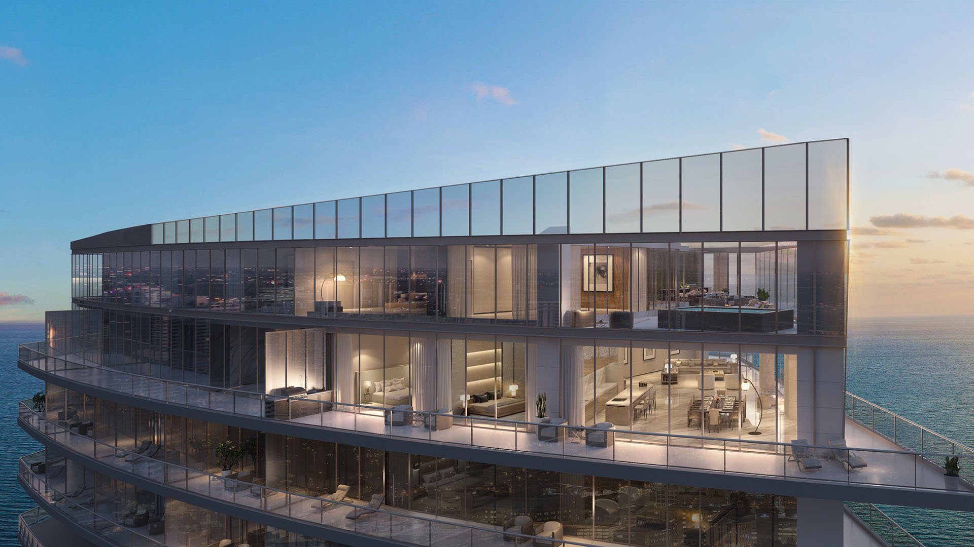 Residences by Armani Casa, Sunny Isles Beach luxury and ultra luxury preconstruction condos, glass-wrapped multi-level exterior with illuminated interiors, expansive terraces, and open ocean views at sunset.