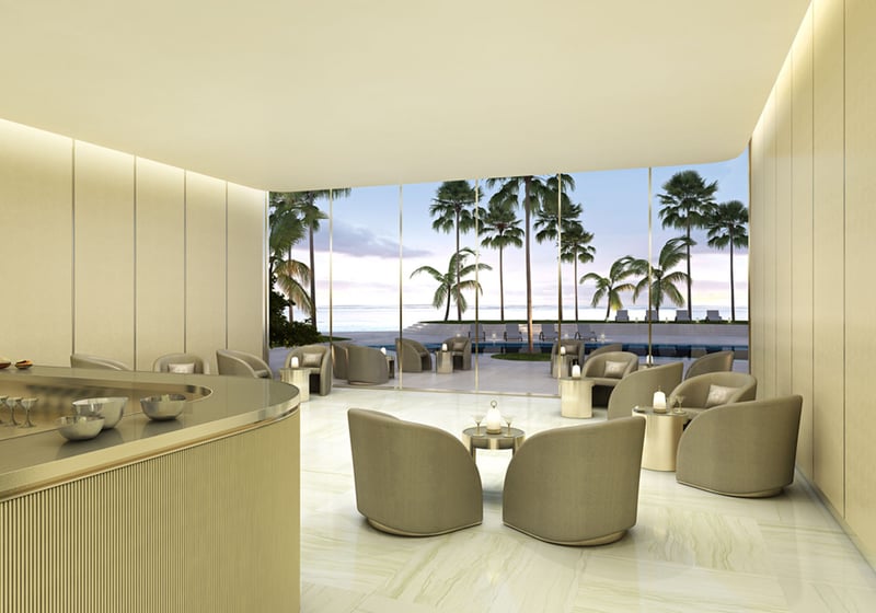 Residences by Armani Casa, Sunny Isles Beach luxury and ultra luxury preconstruction condos, lobby bar lounge with a curved bar, upholstered seating, and palm-filled views beyond the glass.