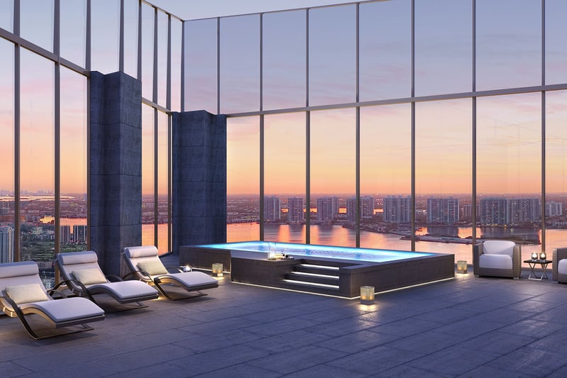 Residences by Armani Casa, Sunny Isles Beach luxury and ultra luxury preconstruction condos, rooftop jacuzzi terrace with chaise lounges, candlelight, and a sunset skyline backdrop.