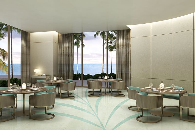 Residences by Armani Casa, Sunny Isles Beach luxury and ultra luxury preconstruction condos, waterfront dining room with turquoise chairs, round tables, and floor-to-ceiling glass.