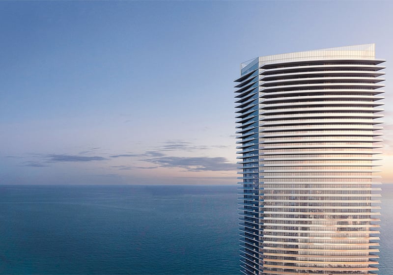 Residences by Armani Casa, Sunny Isles Beach luxury and ultra luxury preconstruction condos, waterfront tower exterior at sunset with sweeping horizontal balconies above the ocean.