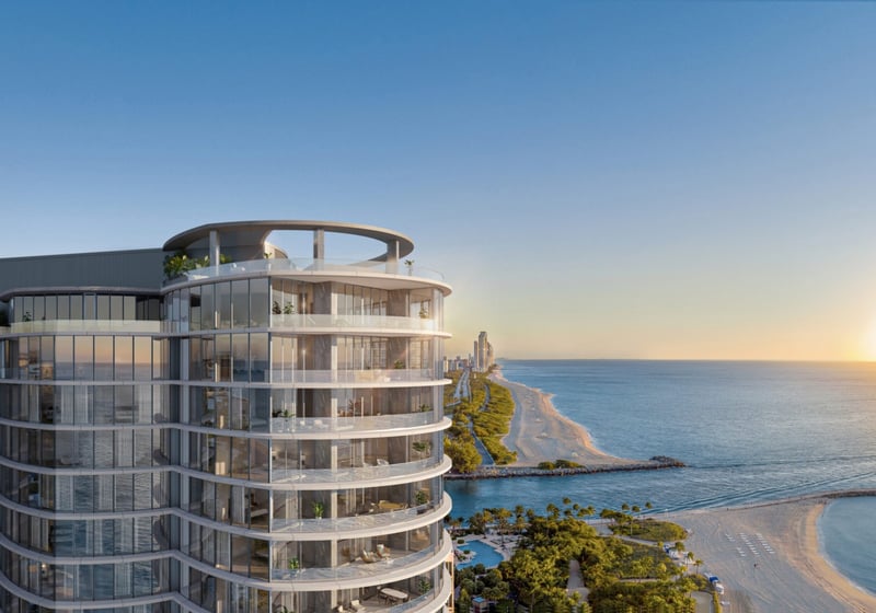 Rivage Bal Harbour modern oceanfront condo at sunset, glass façade over the Atlantic in Bal Harbour, Miami, boutique luxury and ultra luxury condos; preconstruction. Featuring coastal view.