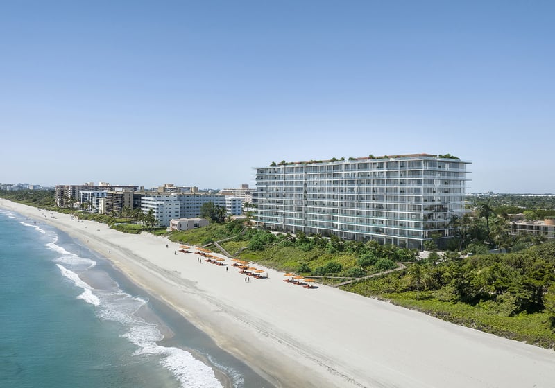 South aerial coastline view of Rosewood Residences Hillsboro Beach, Florida above the Atlantic Ocean and sandy beach, representing luxury and ultra luxury preconstruction condos.