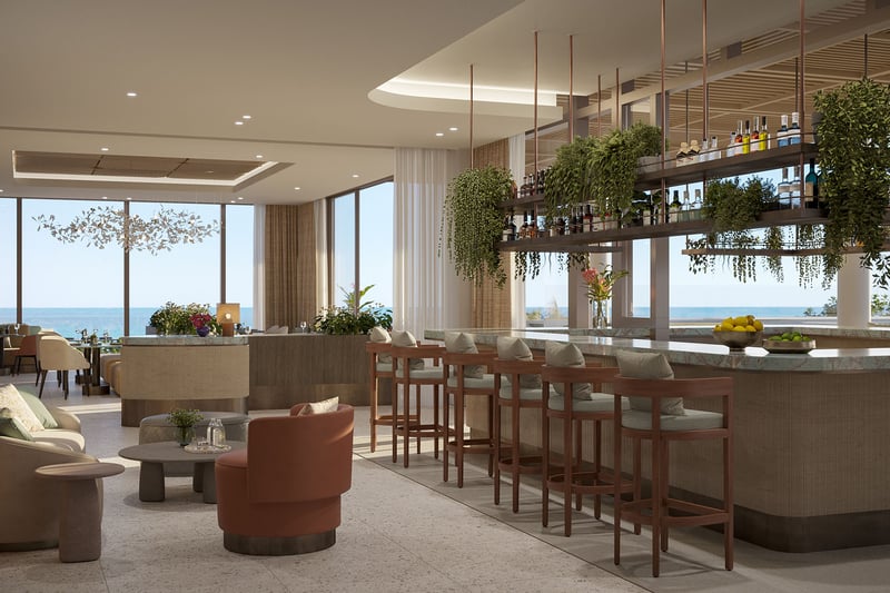 Oceanfront bar lounge interior at Rosewood Residences Hillsboro Beach, Florida, marble counter with hanging bottle shelves and greenery facing the Atlantic Ocean, luxury and ultra luxury preconstruction condos dining.