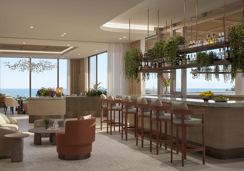 Oceanfront bar lounge interior at Rosewood Residences Hillsboro Beach, Florida, marble counter with hanging bottle shelves and greenery facing the Atlantic Ocean, luxury and ultra luxury preconstruction condos dining.