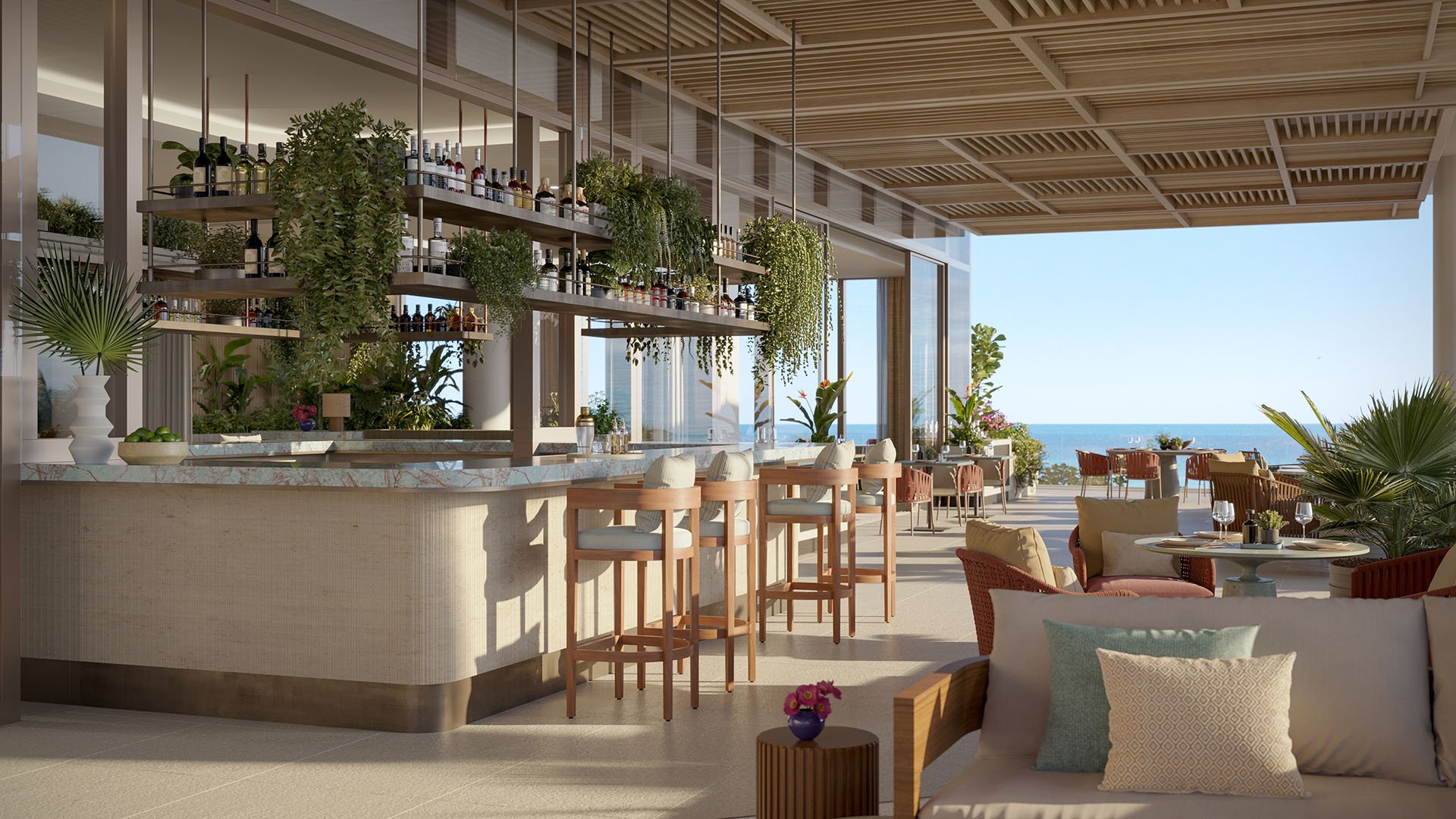 Open-air oceanfront bar terrace at Rosewood Residences Hillsboro Beach, Florida with bar stools, hanging bottle shelves and greenery under a slatted ceiling, Atlantic view, luxury and ultra luxury preconstruction condos.