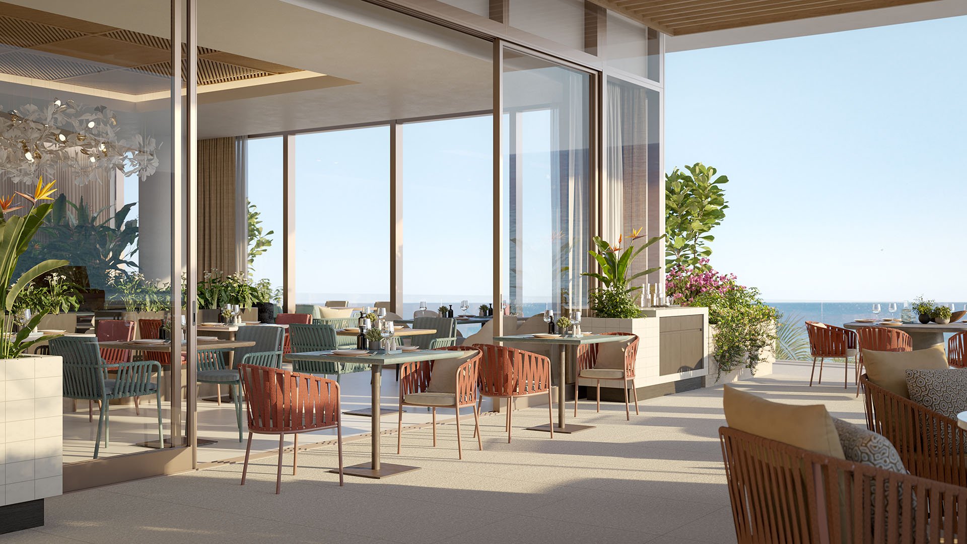 Indoor-outdoor oceanfront dining terrace at Rosewood Residences Hillsboro Beach, Florida with restaurant seating behind glass walls and panoramic Atlantic Ocean views, luxury and ultra luxury preconstruction condos amenities.