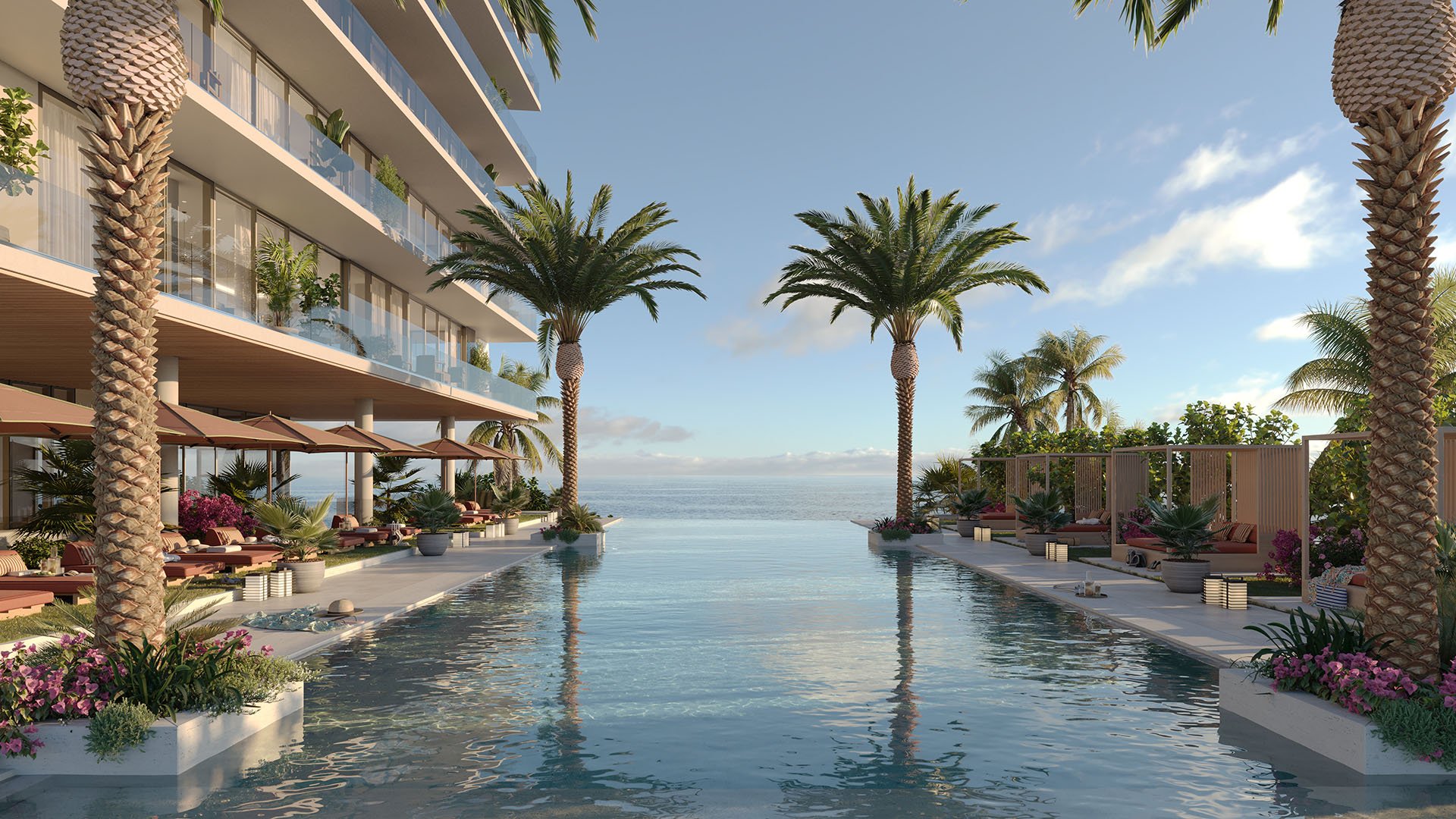 Infinity-edge oceanfront pool at Rosewood Residences Hillsboro Beach, Florida with sun deck cabanas and palm trees facing the Atlantic Ocean, luxury and ultra luxury preconstruction condos resort amenities.