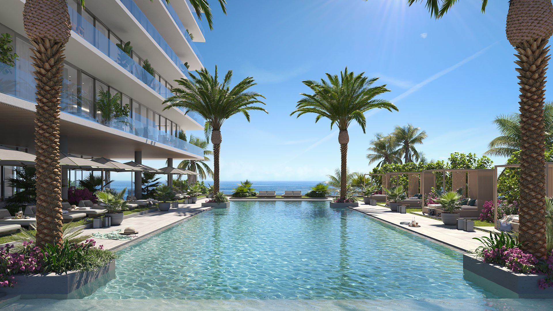 Rosewood Residences Hillsboro Beach, Florida resort-style pool deck with palms, loungers and direct Atlantic Ocean views, amenities for luxury and ultra luxury preconstruction condos.