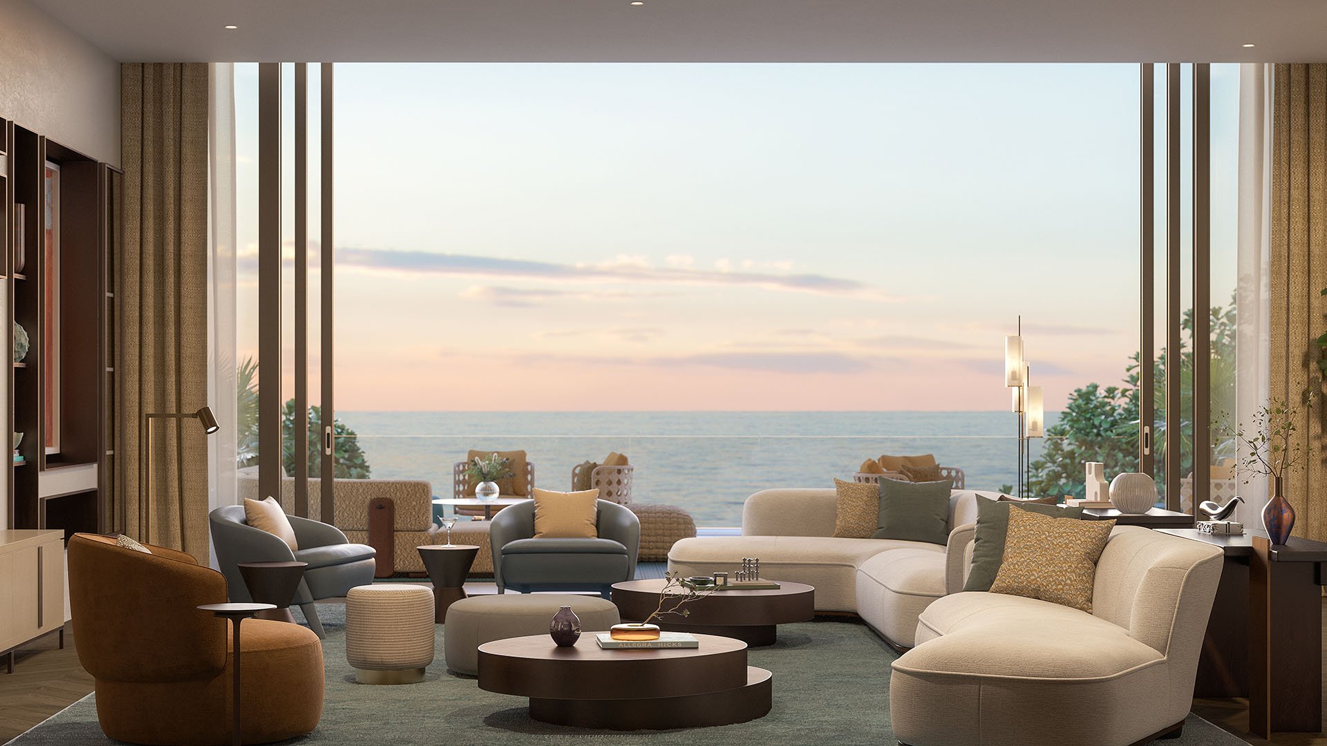 Rosewood Residences Hillsboro Beach, Florida social room lounge with sectional, club chairs and floor-to-ceiling glass framing sunset Atlantic Ocean views, for luxury and ultra luxury preconstruction condos.