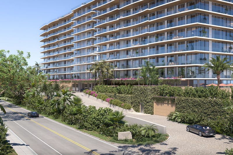 Rosewood Residences Hillsboro Beach, Florida street-view exterior with glass balconies, lush tropical landscaping and arrival driveway, showcasing luxury and ultra luxury preconstruction condos.