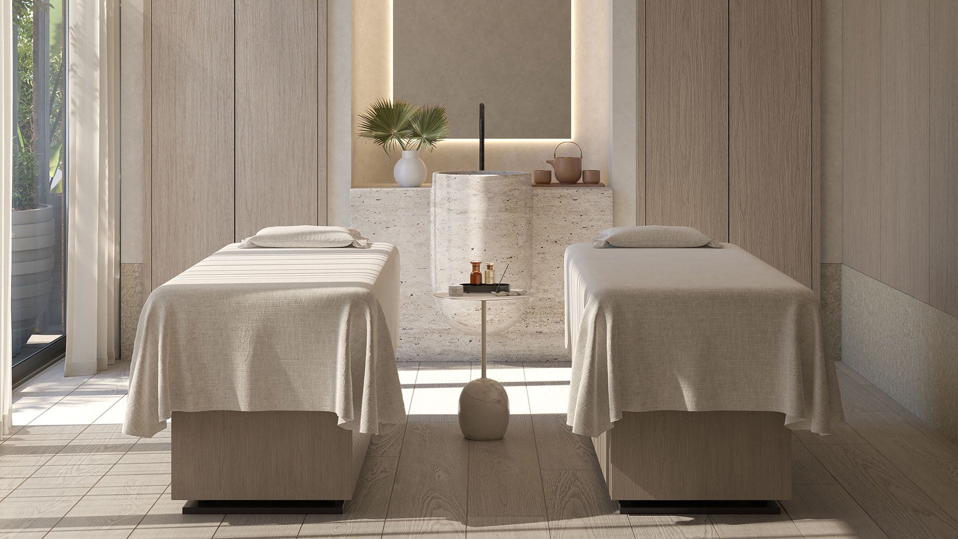 Rosewood Residences Hillsboro Beach spa treatment room with two massage tables, stone vanity and soft lighting, showcasing luxury and ultra luxury preconstruction condos wellness amenities in Hillsboro Beach, Florida.