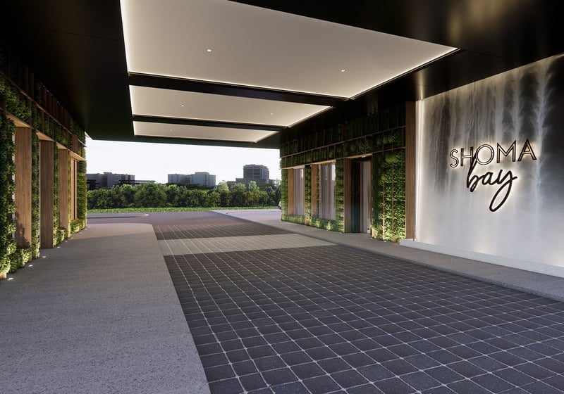 Covered breezeway driveway with living walls and Shoma Bay signage in North Bay Village, Miami, Florida, showcasing luxury and ultra luxury preconstruction condos arrival experience and landscaped entry.