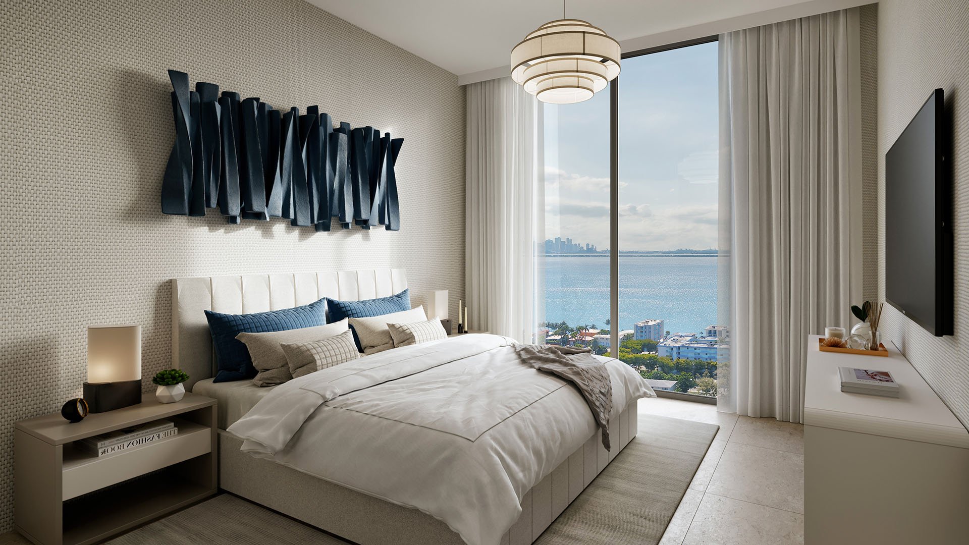 Shoma Bay North Bay Village, Miami, Florida primary bedroom with floor-to-ceiling window framing Biscayne Bay and Miami skyline, designer wall art and modern lighting, showcasing luxury and ultra luxury preconstruction condos.