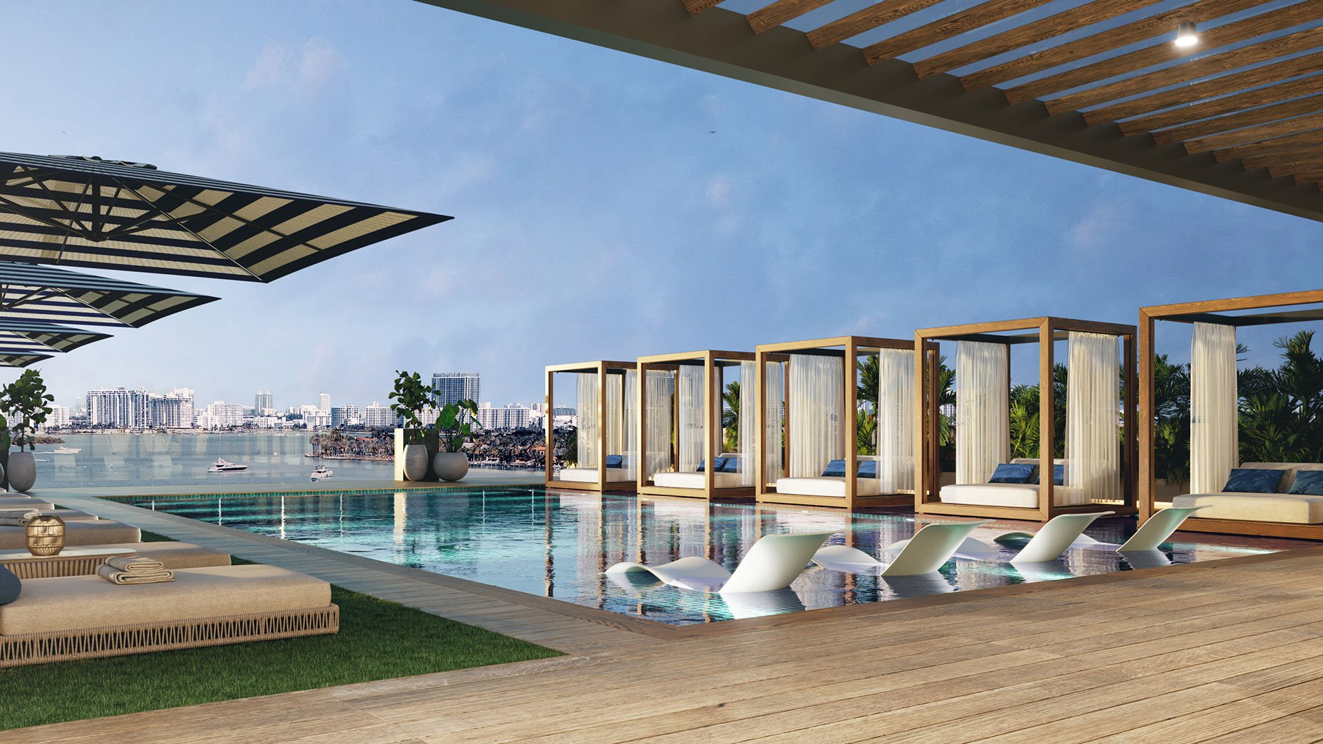 Shoma Bay North Bay Village rooftop pool with private cabanas, sheer drapes and in-water loungers overlooking Biscayne Bay and Miami skyline, highlighting luxury and ultra luxury preconstruction condos amenities.
