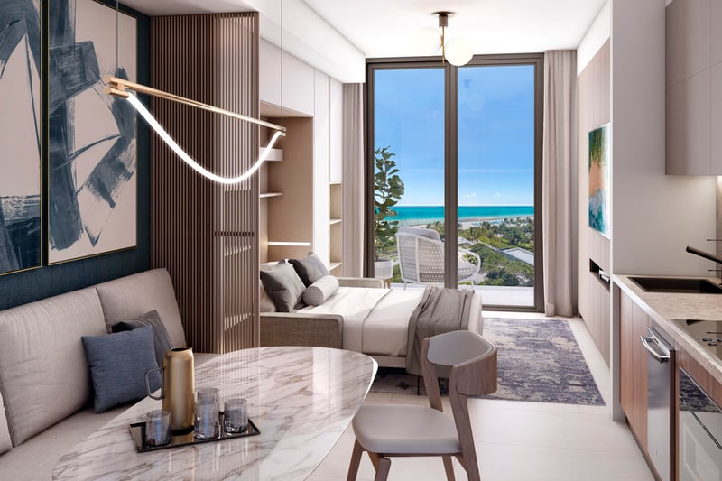Shoma Bay North Bay Village, Miami FL studio condo interior with open layout, kitchenette, dining nook and balcony with ocean view, representing luxury and ultra luxury preconstruction condos.