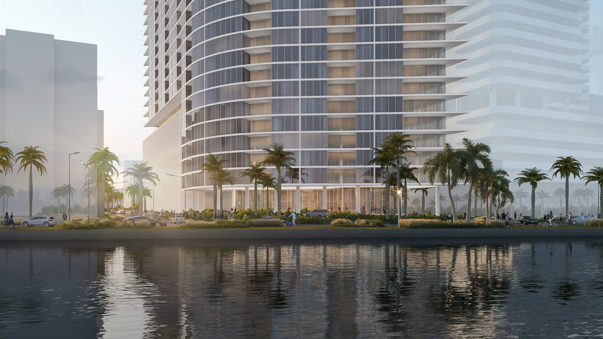 Shorecrest Flagler Drive curved glass tower on the Flagler Drive waterfront in West Palm Beach, Florida - luxury and ultra luxury preconstruction condos with wraparound balconies, palm-lined streetscape and water reflections.