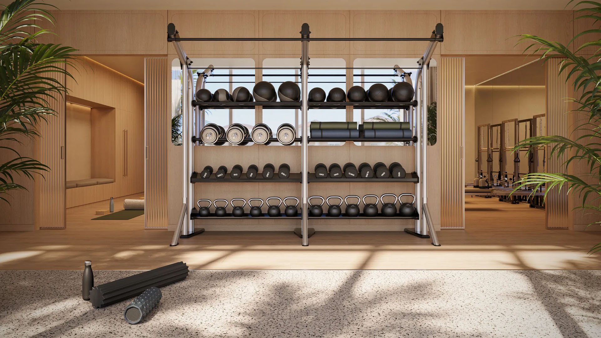 Shorecrest Flagler Drive strength training studio in West Palm Beach, Florida, featuring functional fitness equipment wall with medicine balls, dumbbells and kettlebells - luxury and ultra luxury preconstruction condos gym amenity.