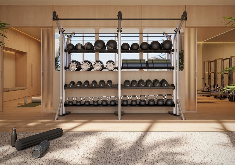 Shorecrest Flagler Drive strength training studio in West Palm Beach, Florida, featuring functional fitness equipment wall with medicine balls, dumbbells and kettlebells - luxury and ultra luxury preconstruction condos gym amenity.