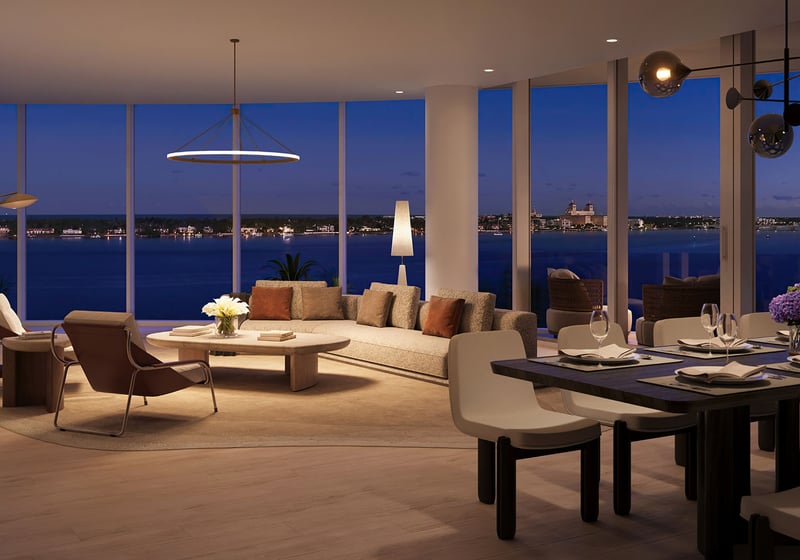 Shorecrest Flagler Drive living and dining room at night in West Palm Beach, Florida, with panoramic waterfront views and designer lighting - luxury, ultra luxury preconstruction condos modern interior.