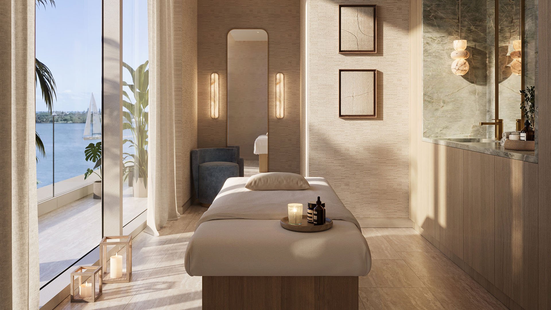 Shorecrest on Flagler Drive in West Palm Beach, Florida spa treatment room with massage table, candles and waterfront view, showcasing luxury and ultra luxury preconstruction condos wellness amenities.