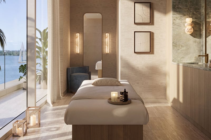 Shorecrest on Flagler Drive in West Palm Beach, Florida spa treatment room with massage table, candles and waterfront view, showcasing luxury and ultra luxury preconstruction condos wellness amenities.