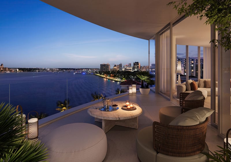 Shorecrest Flagler Drive, West Palm Beach, Florida private terrace balcony with cushioned lounge seating and waterfront night skyline, highlighting luxury and ultra luxury preconstruction condos views.