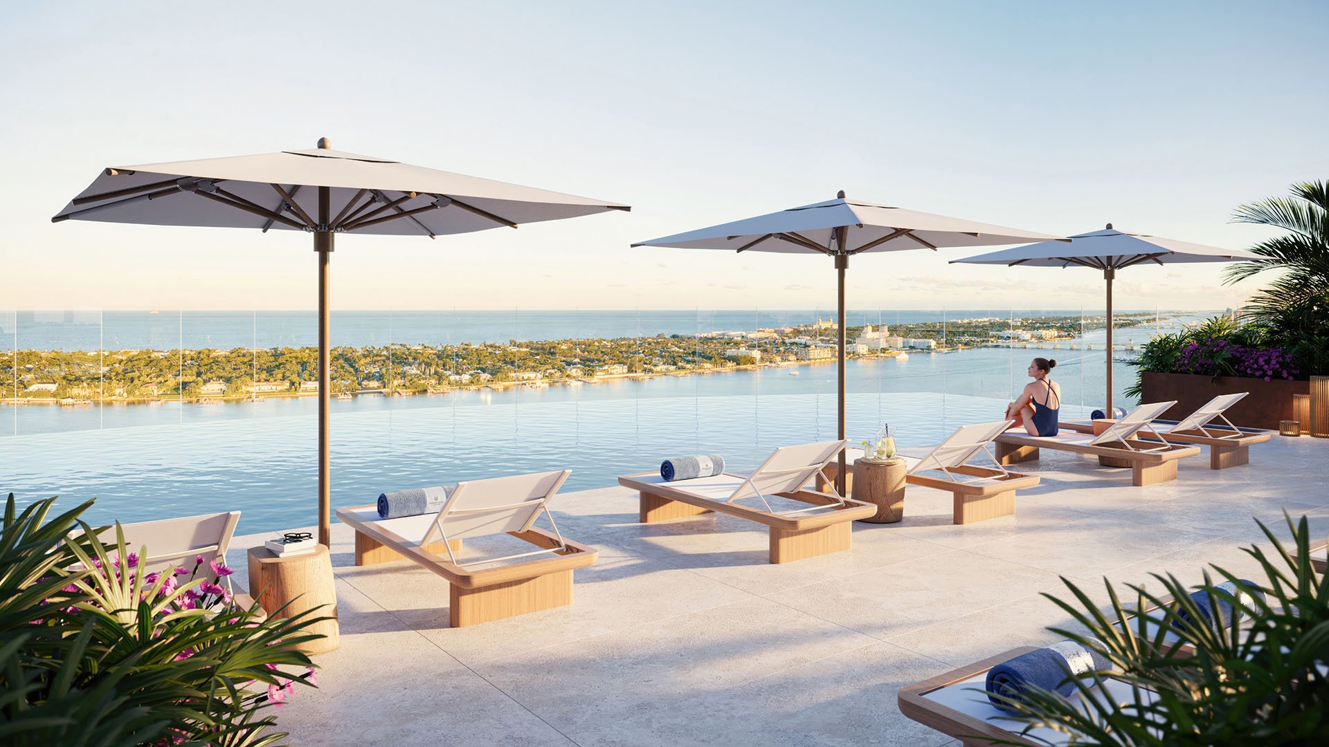 Shorecrest Flagler Drive, West Palm Beach, Florida rooftop pool deck with loungers, umbrellas and panoramic water views, featuring luxury and ultra luxury preconstruction condos resort-style amenities.