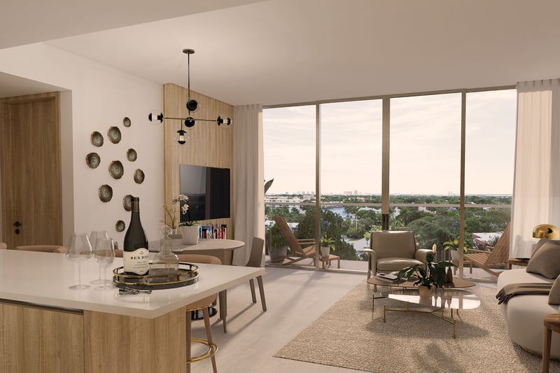 Sixth & Rio luxury and ultra luxury preconstruction condos in Fort Lauderdale, Florida, open living room and kitchen with island and floor-to-ceiling sliding glass doors to balcony with city and water views.