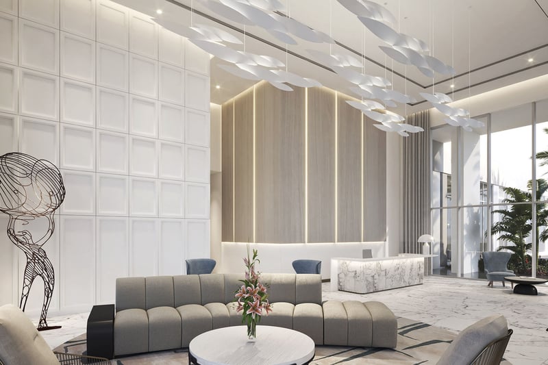 Sixth & Rio luxury and ultra luxury preconstruction condos in Fort Lauderdale, Florida, modern lobby with marble flooring, reception desk, sculptural chandelier and lounge seating.