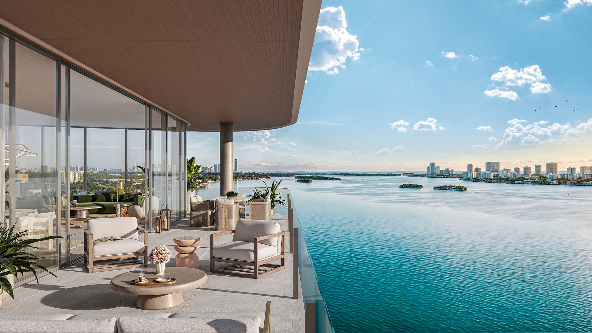 Solana Bay North Miami Beach, Florida Residence A balcony terrace with outdoor lounge furniture and panoramic bay views, highlighting luxury and ultra luxury preconstruction condos waterfront living.