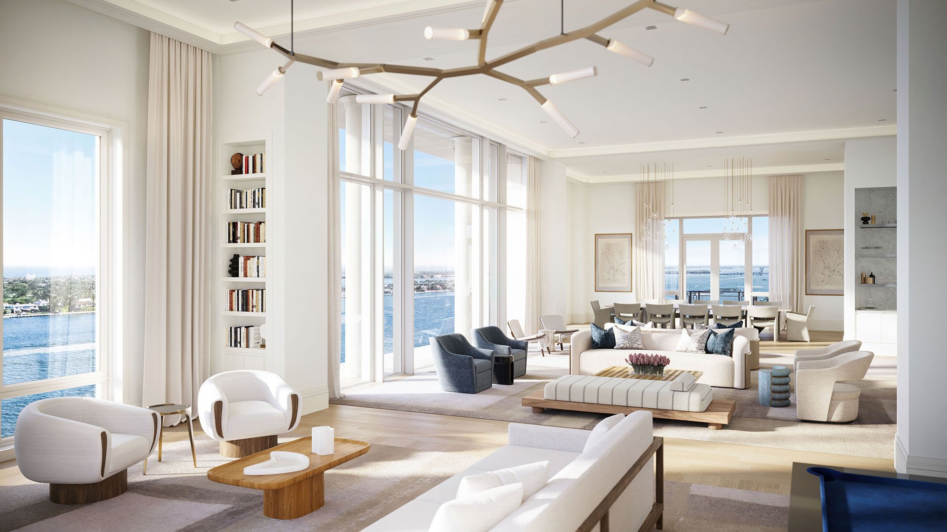 Expansive great room with a sculptural chandelier, multiple seating areas and waterfront views at South Flagler House in West Palm Beach, reflecting luxury and ultra luxury condos with grand entertaining space.