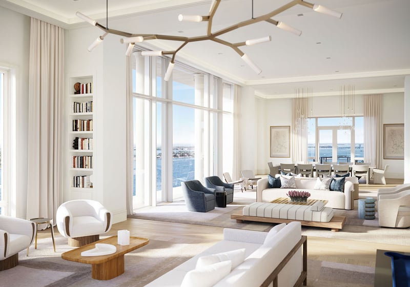 Expansive great room with a sculptural chandelier, multiple seating areas and waterfront views at South Flagler House in West Palm Beach, reflecting luxury and ultra luxury condos with grand entertaining space.