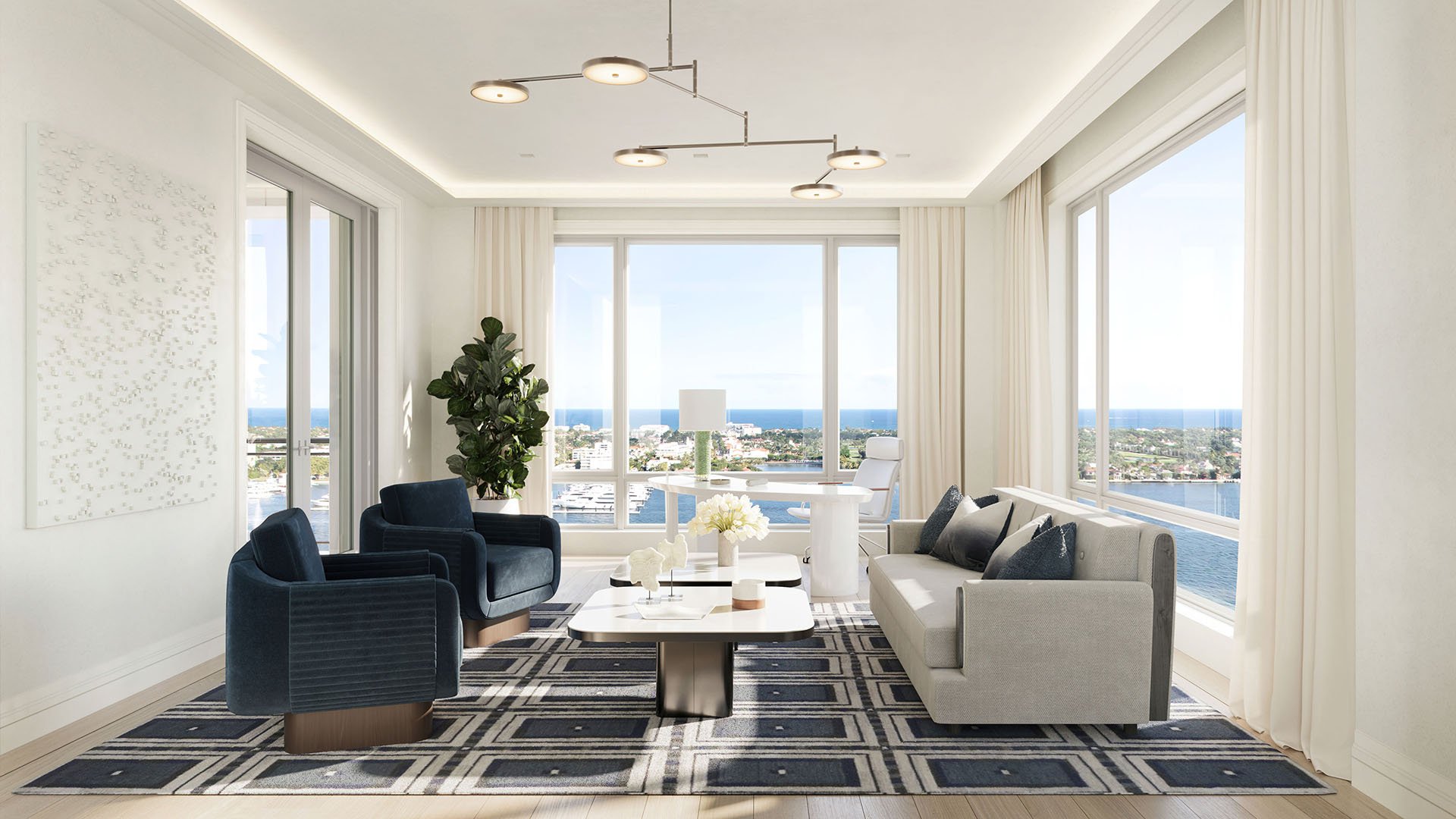 Office lounge with seating, desk area and corner waterfront views at South Flagler House in West Palm Beach, emphasizing luxury and ultra luxury condos with refined work-from-home space.