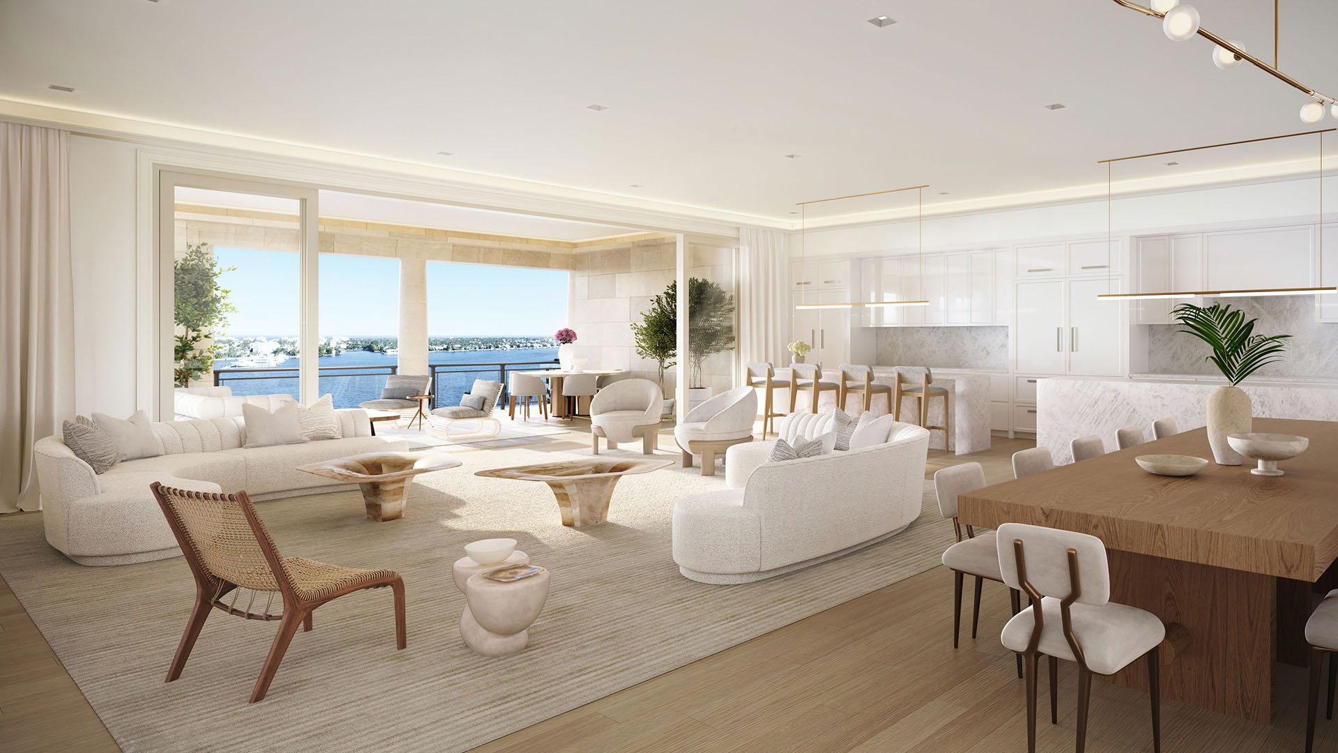 Open great room with kitchen, dining and waterfront seating areas at South Flagler House in West Palm Beach, presenting luxury and ultra luxury condos with spacious open-plan interiors.