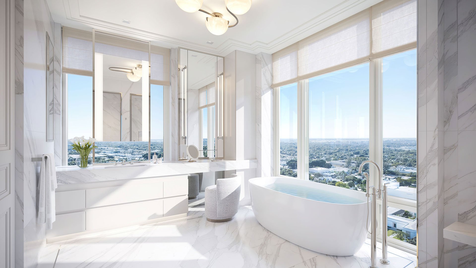 Spa bathroom with a freestanding tub, marble finishes and corner windows at South Flagler House in West Palm Beach, showing luxury and ultra luxury condos with serene waterfront-inspired interiors.