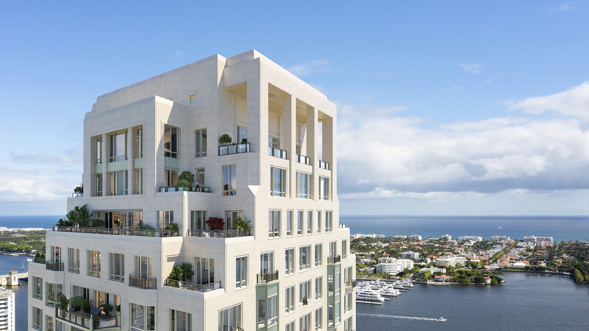 Close aerial view of the stepped tower crown above the waterfront at South Flagler House in West Palm Beach, showcasing luxury and ultra luxury condos with a striking architectural profile.