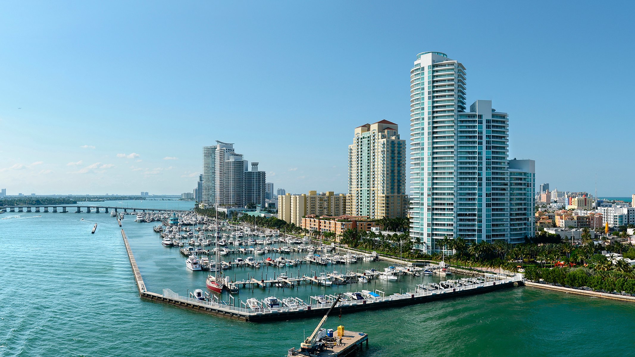 South of Fifth, Miami Beach waterfront cityscape with marinas and promenades, prestigious location for luxury and ultra luxury condos; preconstruction and resale. Featuring coastal.