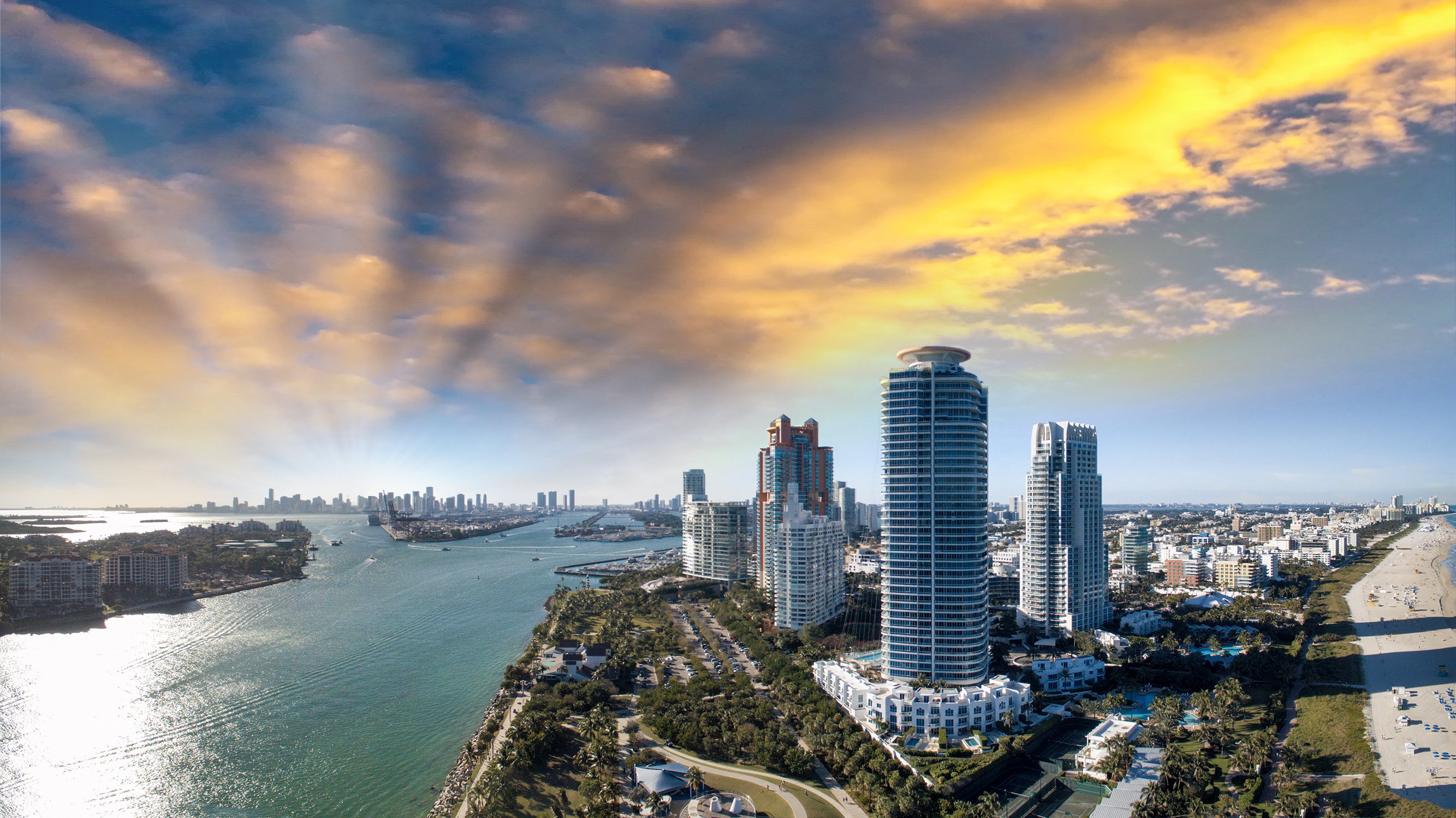South of Fifth waterfront at sunset, pastel sky over Miami Beach skyline—sought‑after setting for luxury and ultra luxury condos; preconstruction and resale.