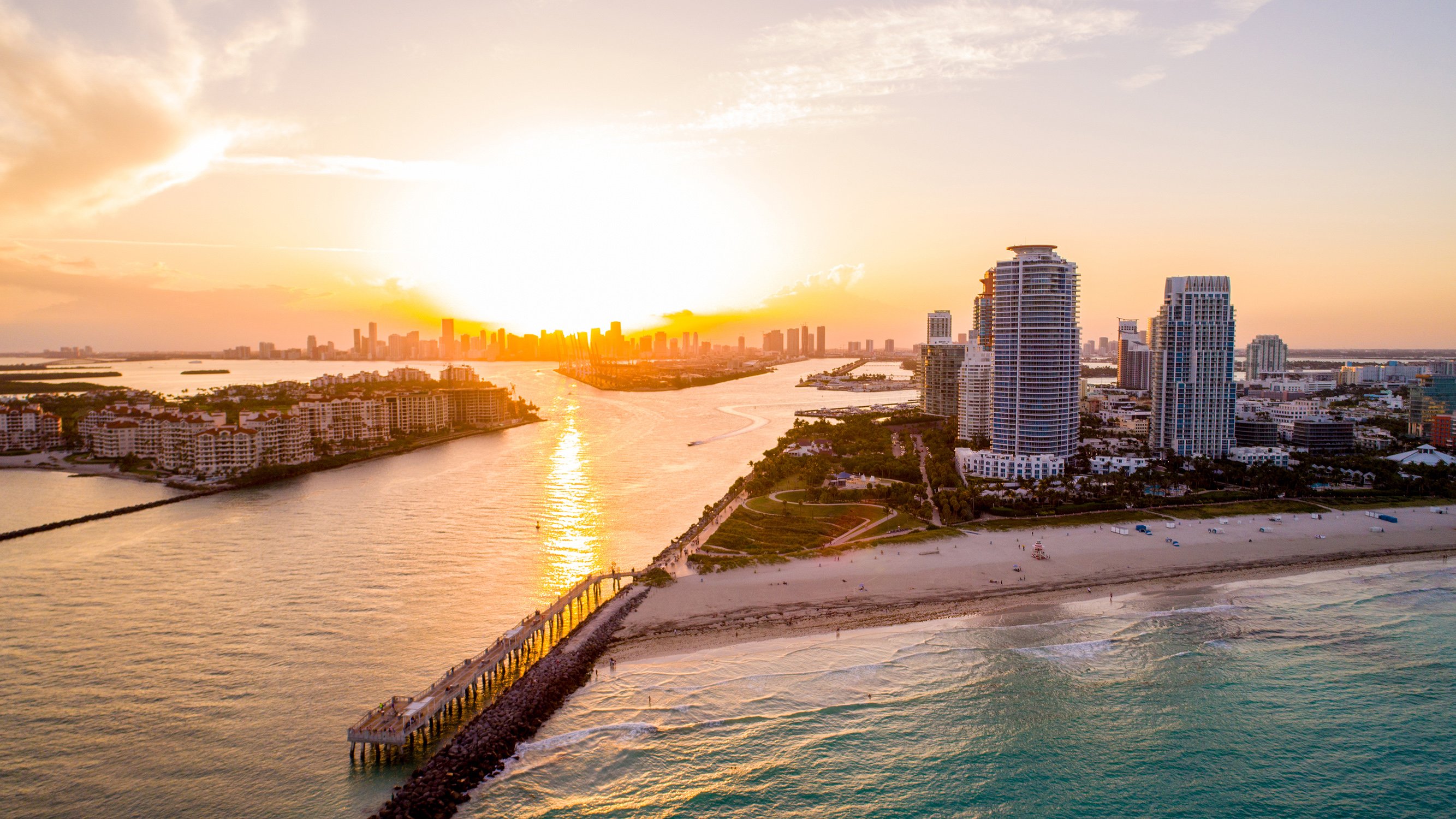 Sunset over South of Fifth, Miami Beach—golden light on skyline and ocean; premier location for luxury and ultra luxury condos; preconstruction and resale.