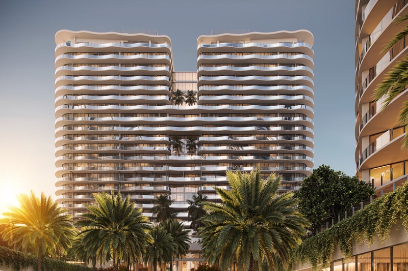 St. Regis Bahia Mar Residences modern tower with palms at sunset, Fort Lauderdale Beach; luxury architecture for ultra luxury condos, preconstruction. Featuring architectural, building, and palm trees.
