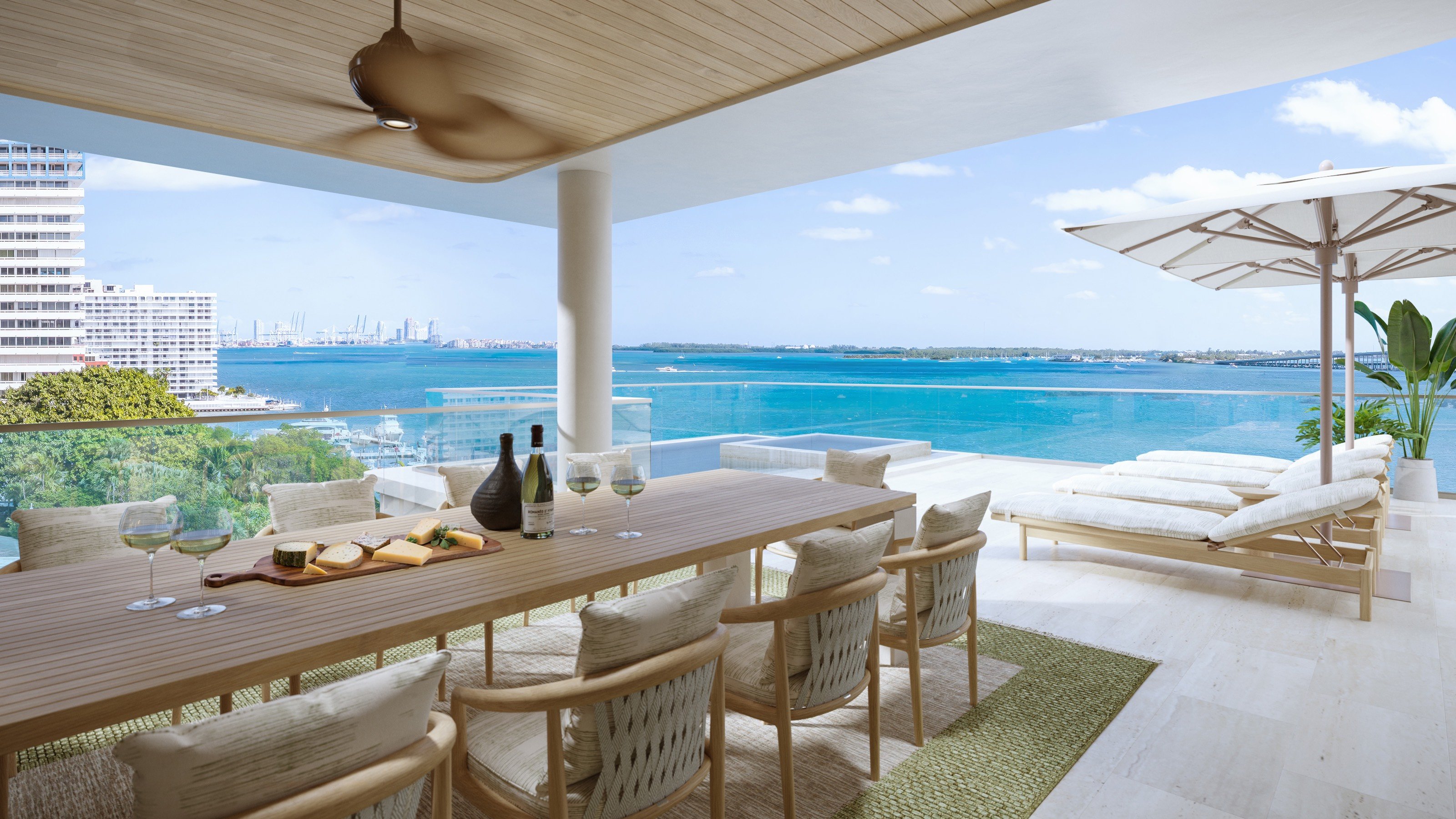 St. Regis Brickell, Brickell Miami bay‑view patio with loungers, indoor‑outdoor living for luxury and ultra luxury condos; preconstruction. Featuring ocean.