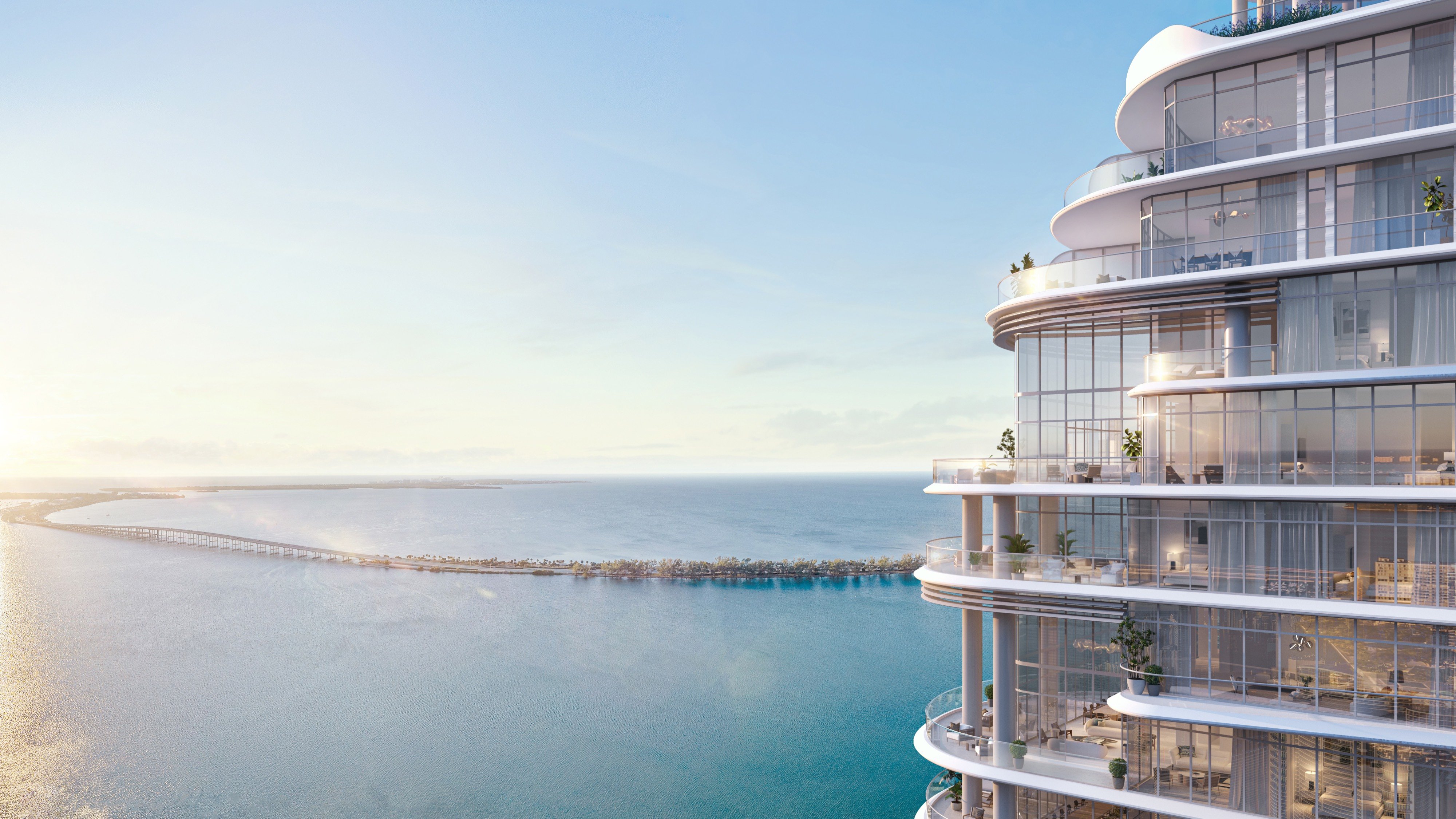 St. Regis Brickell, Brickell Miami bayfront condo at sunset with glowing glass façade, iconic address of luxury and ultra luxury condos; preconstruction. Featuring modern and oceanfront.