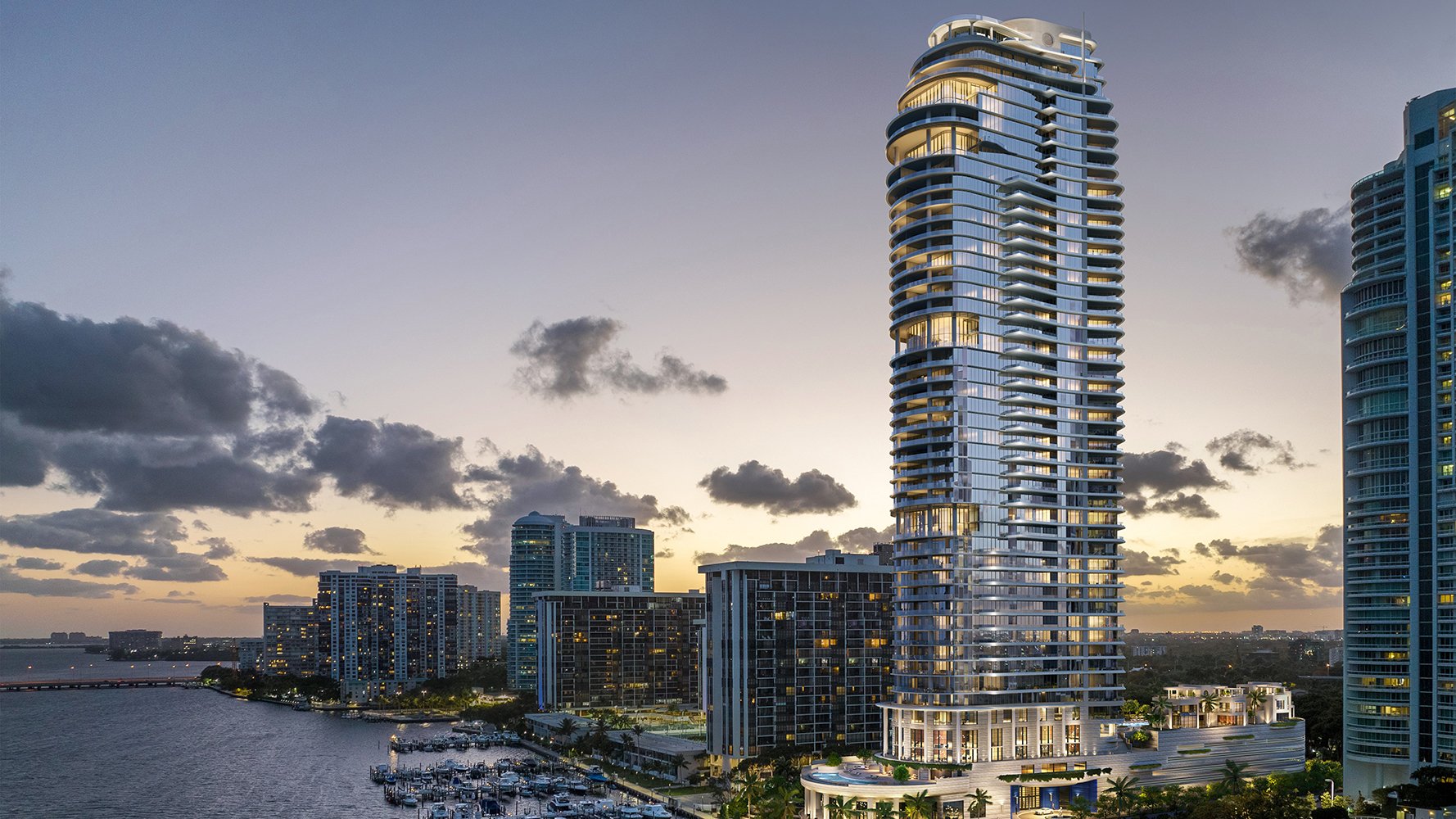 St. Regis Brickell, Brickell Miami modern skyscraper at sunset above Biscayne Bay—landmark tower of luxury and ultra luxury condos; preconstruction.