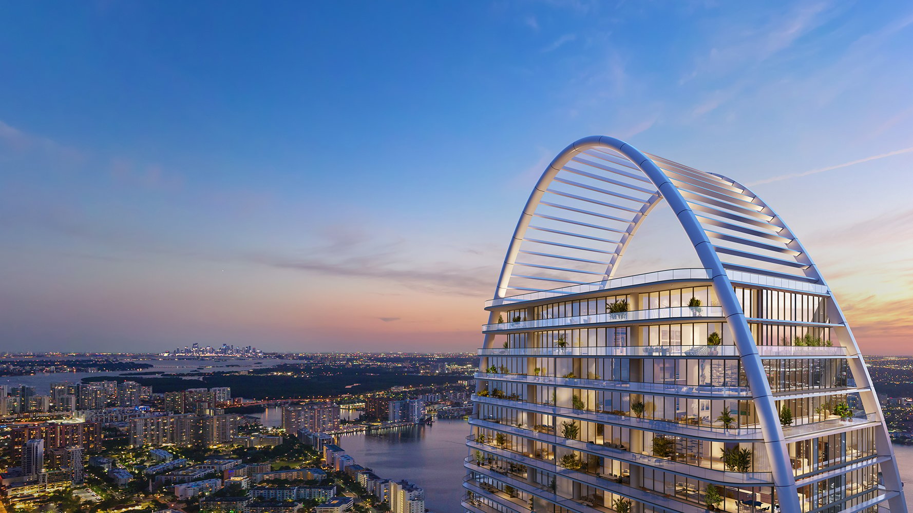 St. Regis Sunny Isles luxury oceanfront tower with modern curved architecture and sunset views over Miami Beach.