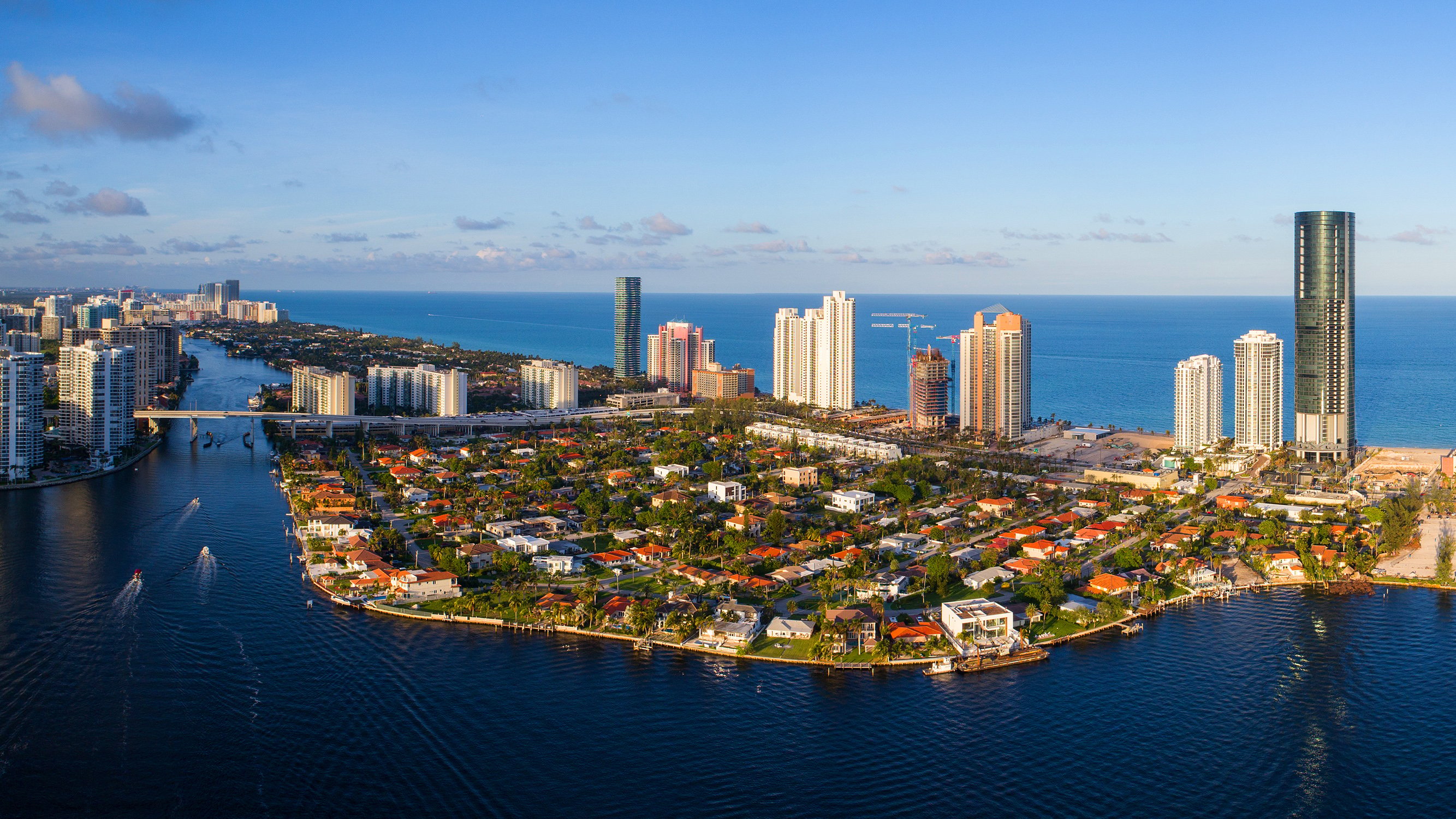 Sunny Isles Beach, Miami‑Dade coastal cityscape with high‑rises and turquoise water-destination for luxury and ultra luxury condos; preconstruction and resale.